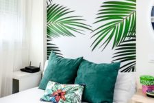 a guest bedroom with a tropical print wall that brings fun and a fresh feel to the space