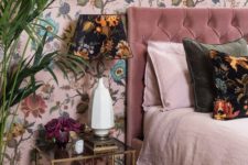 a pink floral wallpaper continues the theme of the bedroom and adds whimsiness to the space