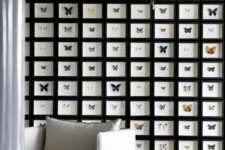a statement gallery wall of black frames all attached to each other and faux butterflies that stand out