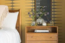 mid-century yellow and grey printed wallpaper is a cool statement idea for a mid-century modern bedroom