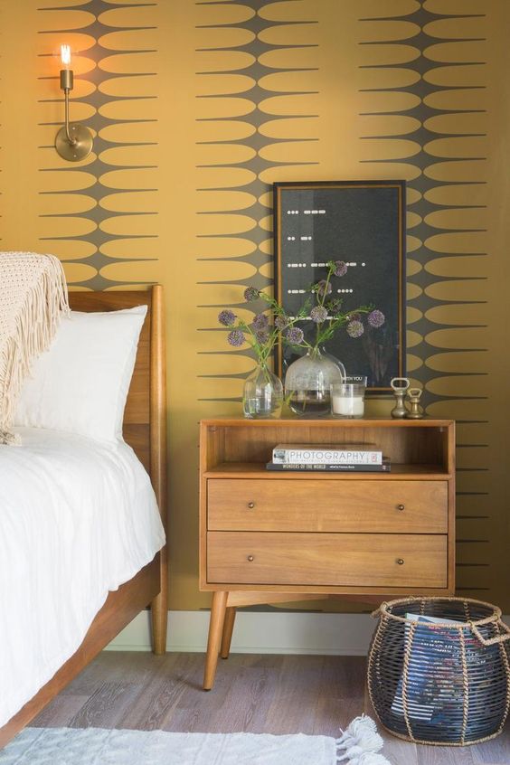 mid century yellow and grey printed wallpaper is a cool statement idea for a mid century modern bedroom
