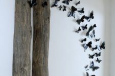 whimsical wall decor of reclaimed wood and 3D black butterflies that are attached to the wall