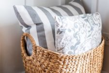 a basket with printed pillows is a nice addition to a living room or another space