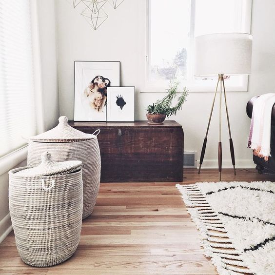 a living room with natural wicker baskets