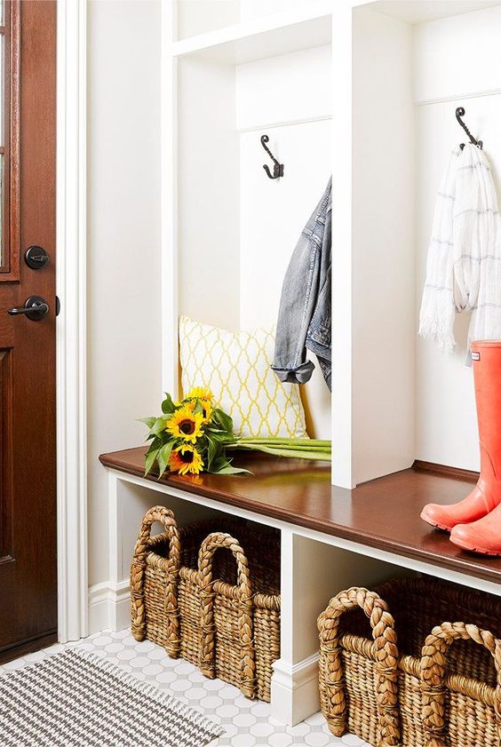 a farmhouse mudroom with a large storage unit, with large wicker cubbies that highlight the style