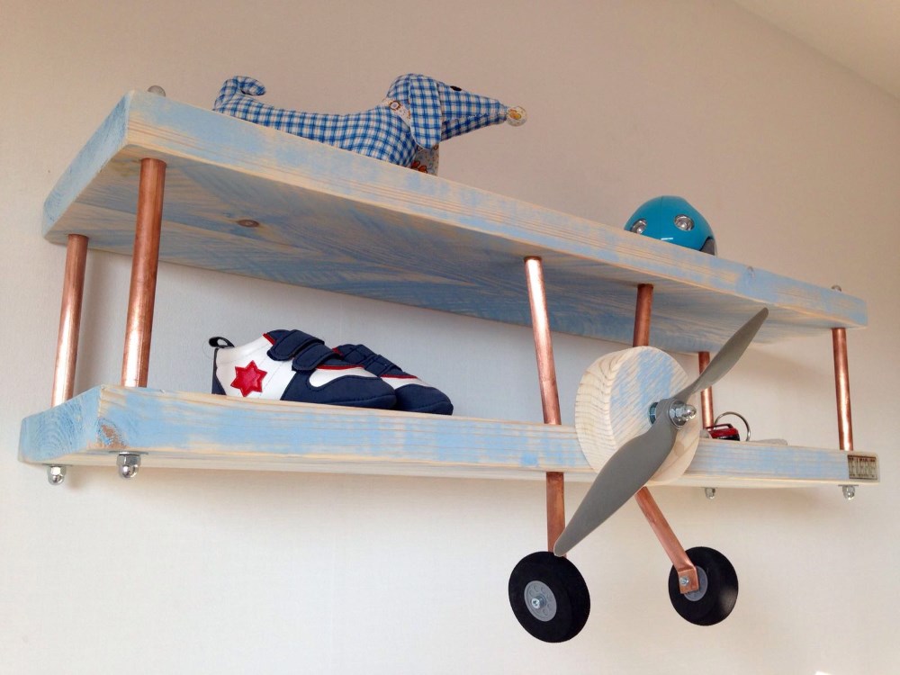 you can diy an airplane shelf for a boys room using to wood boards and copper pipes