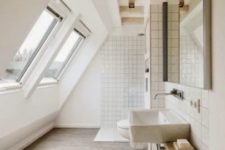 a large neutral attic bathroom with skylights, a white shower space, wooden beams and a floating sink