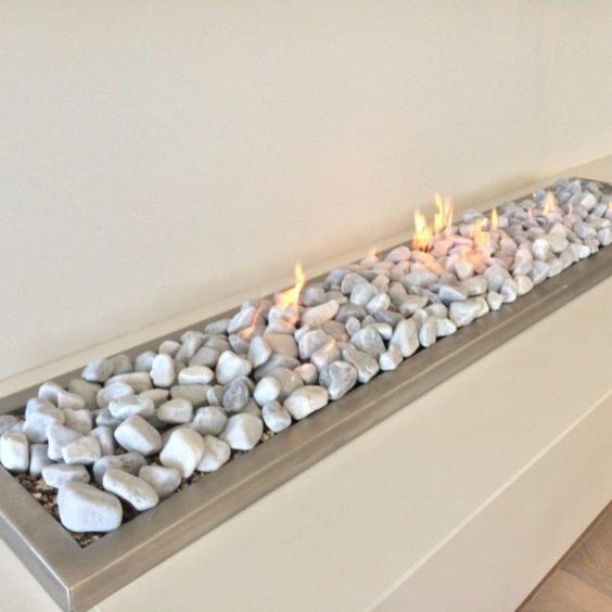 a vent free gas fireplace with pebbles looks very natural and very up-to-date at the same time