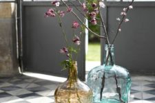large bottles in blue and brown with blooming branches make the space fresh, bright and spring-filled