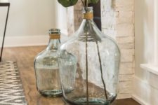 oversized bottles with twine and some green leaves by the fireplace to make the space chic and fresh