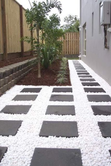snow white pebbles plus dark tiles for creating a bold and contrasting look in the backyard ara