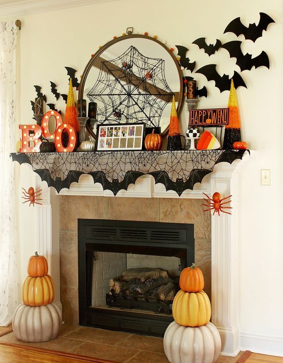 a bright and fun Halloween mantel with a spiderweb, marquee letters, bats, pumpkins and candy corns is cool