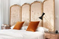 a refined fabric upholstered headboard is a chic idea and rust-colored pillows add to it