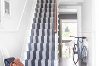 a striped runner in shades of gray is a great addition to white surroundings
