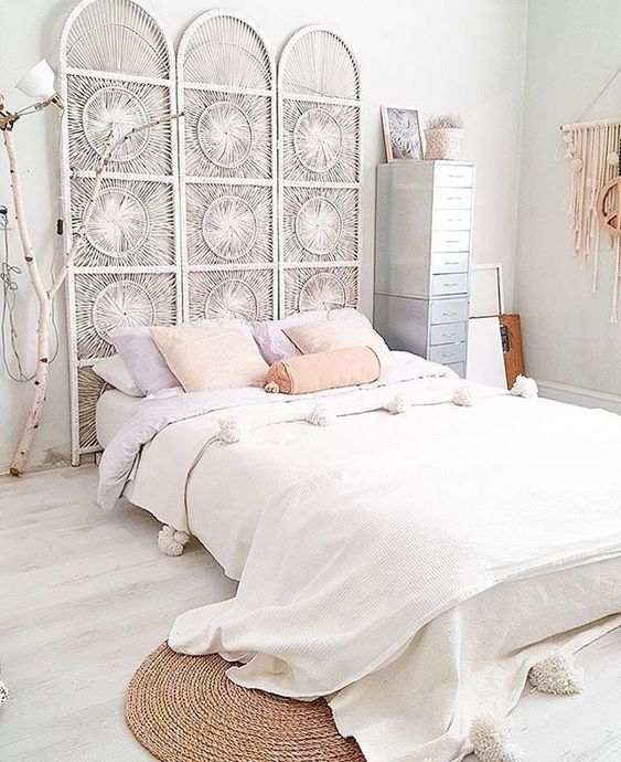 a whitewashed boho screen headboard adds a chic texture and look to the space without taking over it