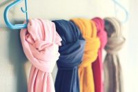 simple single coat hanger can store several scarves by knitting thme near each other