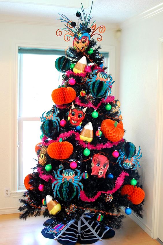 a black Halloween tree with bright paper pumpkins and spiders, scary masks and colorful ornaments