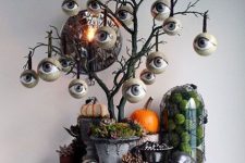 a black Halloween tree with lots of eyeballs, with pumpkins and spiders under it is a catchy idea