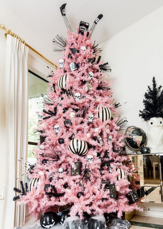 a creepy cute Halloween tree with black and white ornaments, striped ones, jack-o-lanterns and twigs