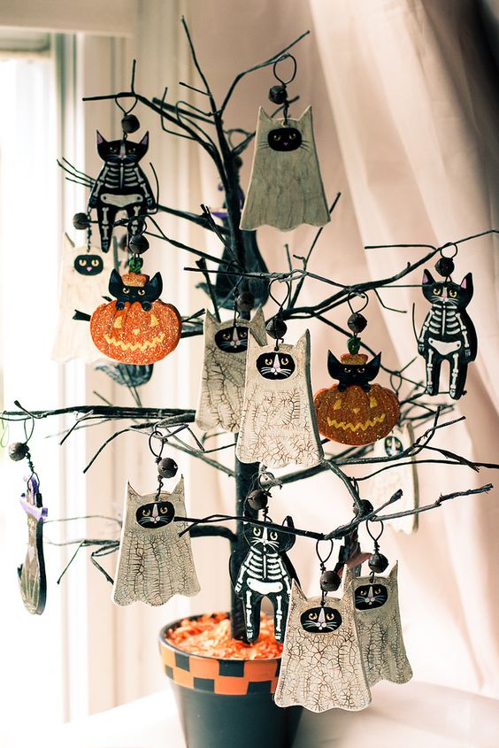 a mini black Halloween tree with skeleton cats, bats and pumpkins is a very cool and fun idea