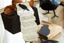 a stylish Halloween party invite with a raw hem and a blackbird in a black box with eggs