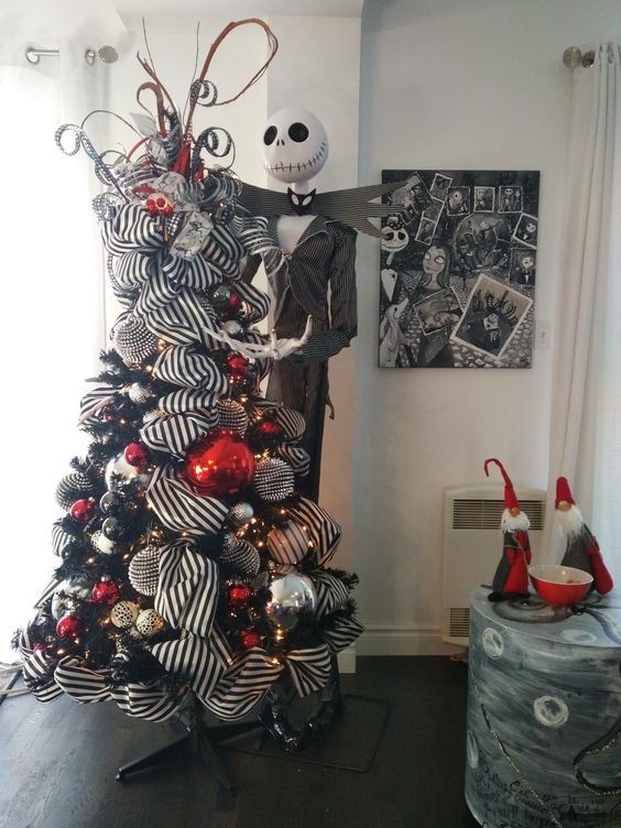 an elegant black Halloween tree with striped garlands, red, silver and black ornaments plus Jack Skellington