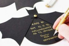 black bat invitations with gold letters are simple and very cool, they look glam and bold