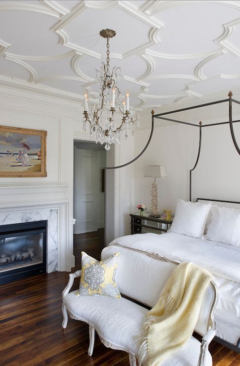 chic and elegant molding on the ceiling plus a crystal chandelier create a gorgeous backdrop for super elegant furniture
