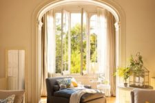 vintage molding and trim plus an arched doorway make the space vintage, yet the neutral soft shade add a relaxing feel