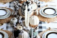 a cozy Thanksgiving centerpiece of white, plaid, color block pumpkins, antlers, cotton and candles is very chic