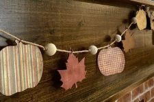 a fall garland of plywood pumpkins, leaves and wooden beads is a lovely idea for Thanksgiving
