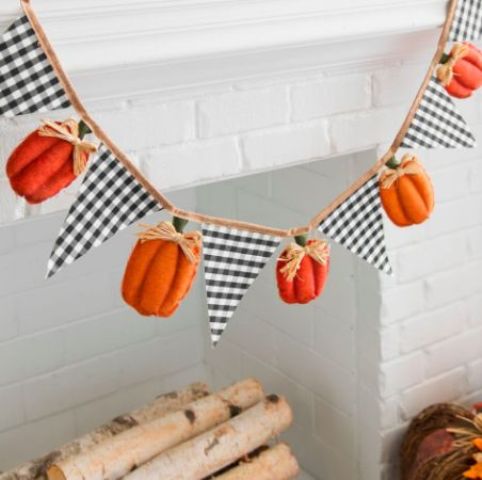 a fall or Thanksgiving garland of plaid triangles and pumpkins with twine is a stylish decoration with a rustic feel