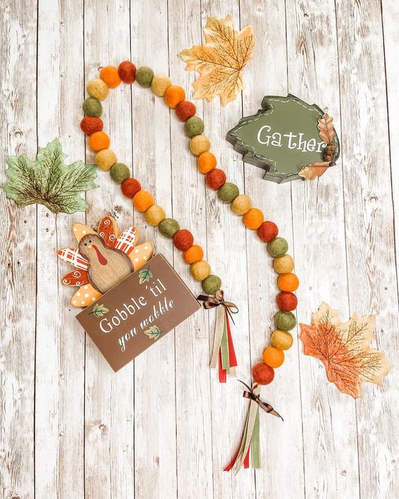 a felt bead garland done in fall colors, tassels and ribbon bows is a nice decor idea you can eaisly realize