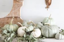 a fresh natural mantel with eucalyptus and heirloom pumpkins for a beautiful Thanksgiving mantel