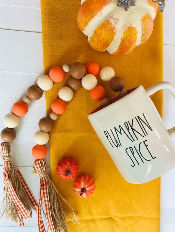 a wooden bead Thanksgiving garland in fall colors with twine and plaid ribbons is also goof for the fall