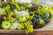 seasonal pumpkins, gourds, pinecones and flowering branches in a wooden bowl is perfect for Thanksgiving