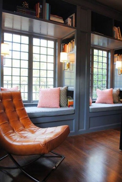 two cozy reading nooks at the windows with bookshelves on the walls and over them are perfect
