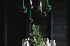 Christmas chandelier decor with green, purple and red velvet ornaments is a cool decoration