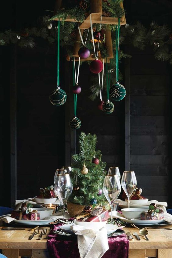 Christmas chandelier decor with green, purple and red velvet ornaments is a cool decoration