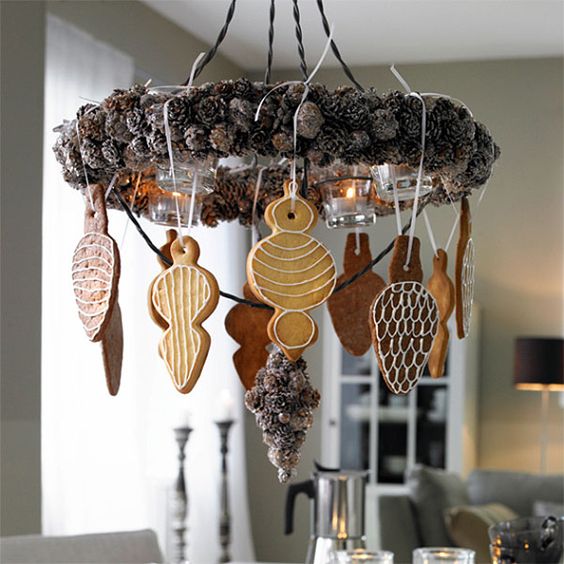 a Christmas chandelier of pinecones and cookies hanging down is a very creative idea
