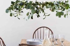 an ethereal Christmas chandelier of greenery and silver bells is a beautiful holiday decor idea to rock