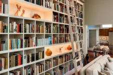 an oversized white bookcase with enlit niches and a ladder is a cool idea, take a whole wall if necessary