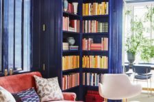 bright blue lacquered bookcases built into the walls are a great idea to make the space bright and to store books