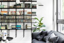 floating black open shelves and dark furniture stand out in a neutral space and enliven it