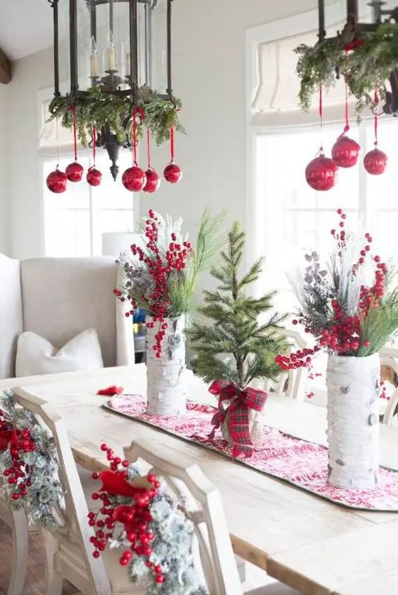 Vintage lantern styled chandeliers with evergreens and red ornaments are amazing for classic holiday decor