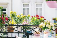 hang flower pots on the railing as a space saving solution