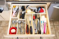 DIY kitchen utensil organizer made of simple lumber boards that are glued together