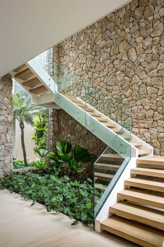a mini indoor garden under the stairs is a gorgeous refreshing feature to bring some outdoors inside