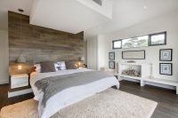 covering a wall behind a bed with rustic laminate boards could add an intersting touch to a bedrooms design