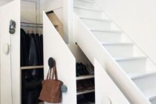 a clever under stairs storage solution to store bags